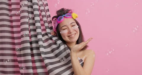 Spa and body washing concept. Happy young Asian woman keeps palm raised catches Stock Footage 147994765