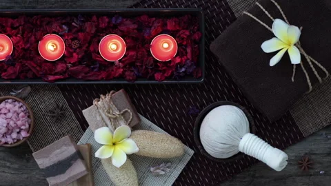 Spa and wellness Decorations on the table with candles and flower petals Stock Footage 247459157