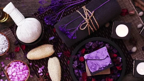 Spa and wellness Decorations on the table with candles and flower petals in.. Stock Footage 247459363