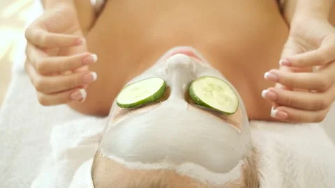 Spa. Applying a mask on the face and cucumber. Skin rejuvenation. Health and Stock Footage 139388353