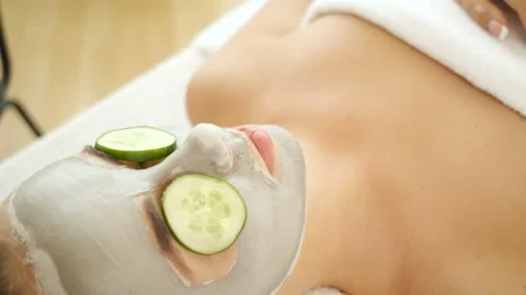Spa. Applying a mask on the face and cucumber. Skin rejuvenation. Health and Stock Footage 140311289