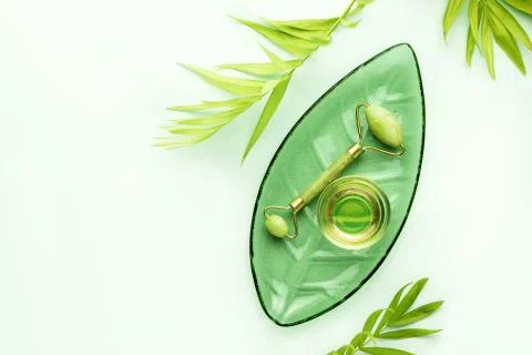 Spa background with jade roller and massage natural oil Stock Photos
