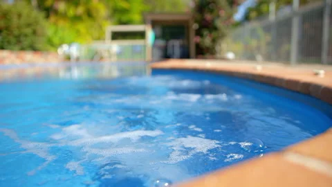 Spa bubbles in a swimming pool on a summers day Stock Footage 241630048