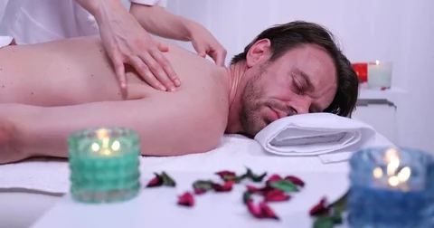 Spa Client Sophisticated Man Lying on His Front Receiving a Neck Body Massage Stock Footage 80286723