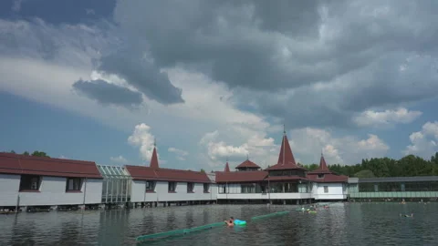 Spa complex on thermal Heviz lake and dramatic cloudy sky, Hungary - 4K Stock Footage 190826996