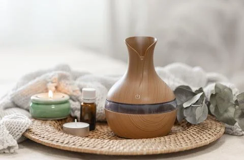 Spa composition with aroma oil diffuser lamp on a blurred background. Stock Photos