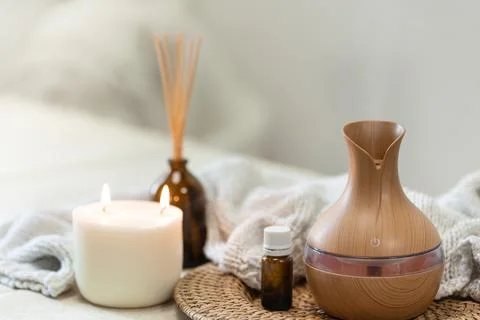 Spa composition with aroma oil diffuser lamp on a blurred background. Stock Photos