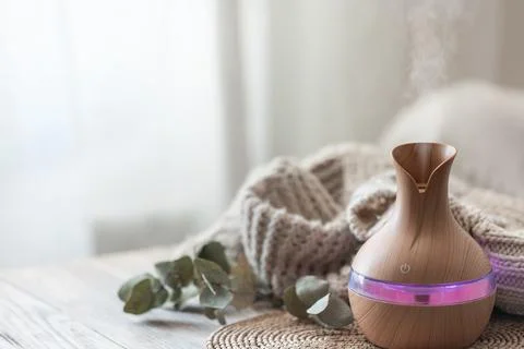 Spa composition with aroma oil diffuser lamp on a blurred background. Stock Photos