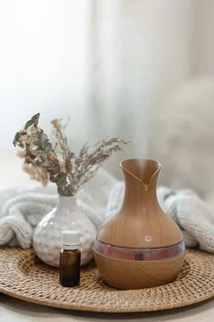 Spa composition with aroma oil diffuser lamp on a blurred background. Stock Photos