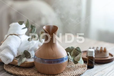 Spa composition with aroma oil diffuser lamp on a blurred background ...