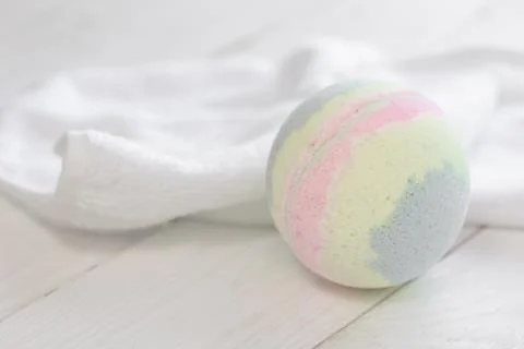 Spa composition with bath bomb and towel, close-up. Stock Photos