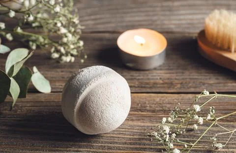 Spa composition with bath bomb, candle and dried flowers. Stock Photos
