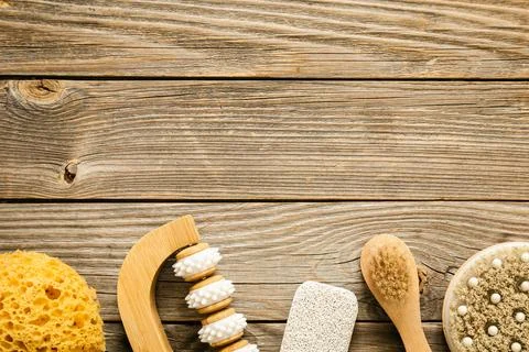 Spa composition with brushes, washcloth and massager on a wooden background. Stock Photos
