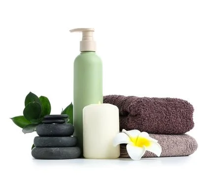 Spa composition with burning candle, stones and bottle of cosmetic product is Stock Photos