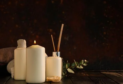 Spa composition with burning candles and reed diffuser on black grunge backgr Stock Photos