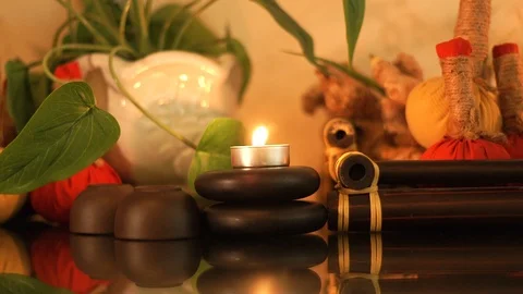Spa composition burning candles, stones for body massage, aromatic herbs and cup Stock Footage 103268324