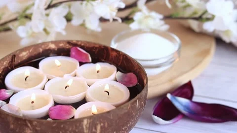 Spa composition with coconut bowl, rose and tulip petals Video stock 234797073
