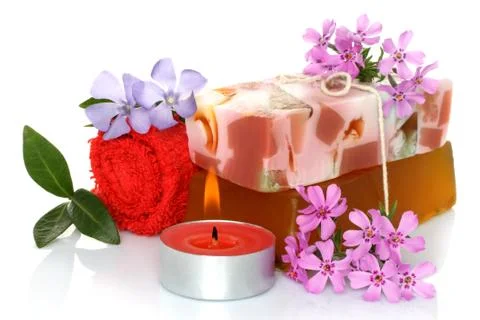 Spa composition of handmade soap, towel, flowers and candle . Stock Photos