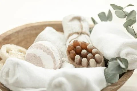 Spa composition with soap, bath bomb and towels in a wooden bowl. Stock Photos