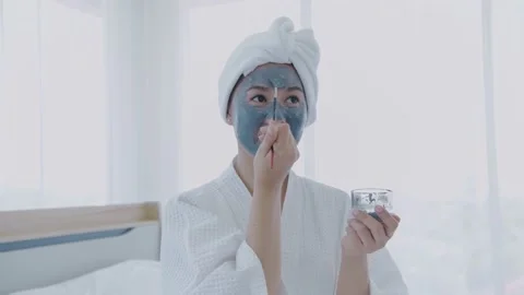Spa concept of 4k Resolution. Asian woman applying facial cream in bedroom. Stock Footage 151721215