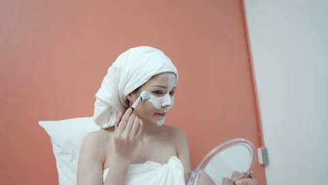 Spa concept of 4k Resolution. Asian woman applying facial cream in bedroom. M Stock Footage 166579698