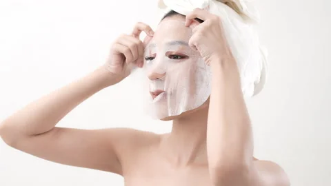 Spa concept of 4k Resolution. Asian woman putting face mask on white backgrou Video stock 210224449