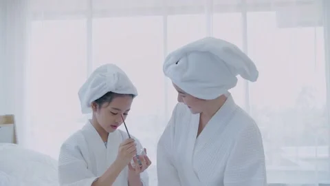 Spa concept of 4k Resolution. The daughter was applying face mask to her moth Stock Footage 154166291