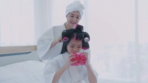 Spa concept of 4k Resolution. Mom combing her hair for daughter in bedroom. Stock Footage 144402230