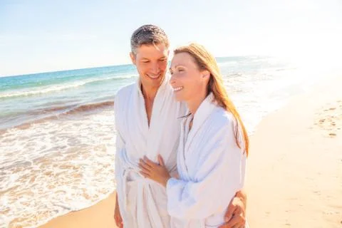 Spa couple relaxing while walking beach Stock Photos