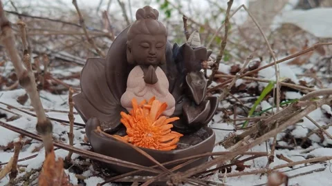Spa decor with a deity figure meditating on a winter nature background Stock Footage 324993492