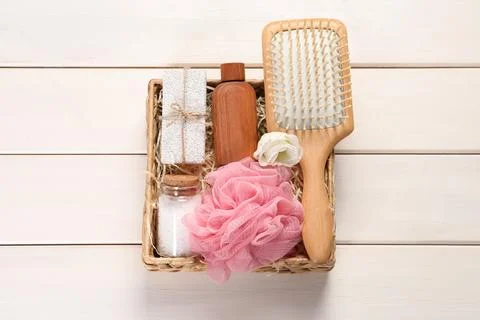 Spa gift set with different products in wicker box on white wooden table, t.. Stock Photos