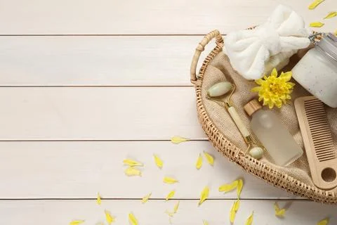 Spa gift set with different products in wicker basket on white wooden table.. Stock Photos