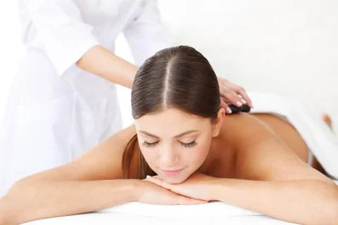 Spa hot stone massage Stock Photos