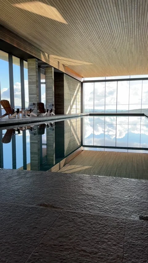 SPA interior with swimming pool and chairs with big windows. Empty. Vertical Stock Footage 230582584