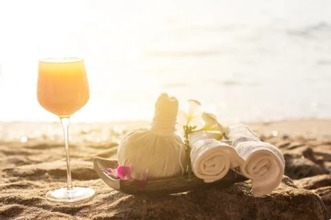 Spa kit set and soft drink putting on the beach spa bed preparation. Stock Photos