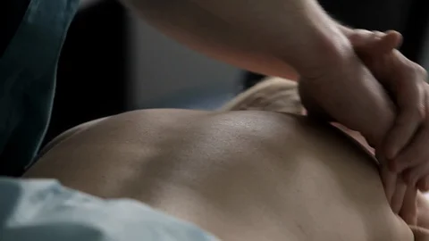 In spa massage therapist performs procedure of spinal massage to woman. Stock Footage 100269120