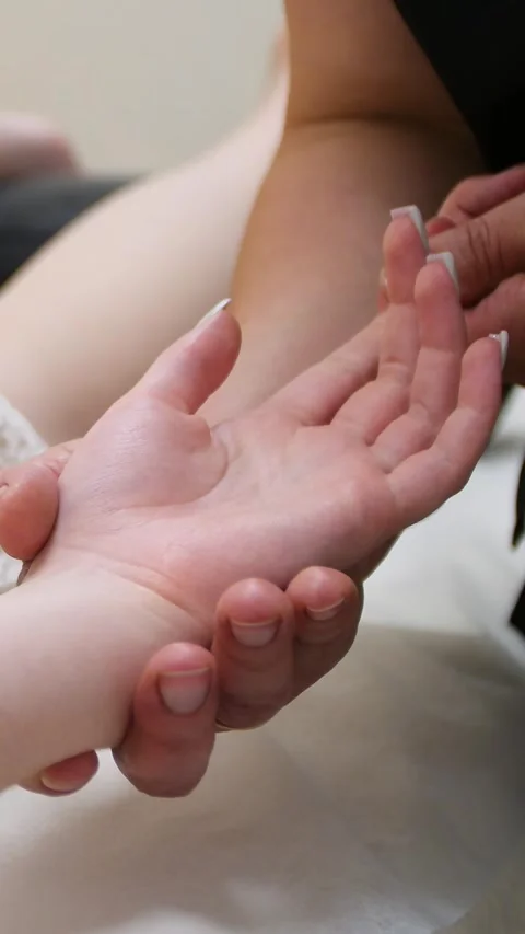 Spa. A massage therapist is working with a young woman - Vertical video Stock Footage 336484954