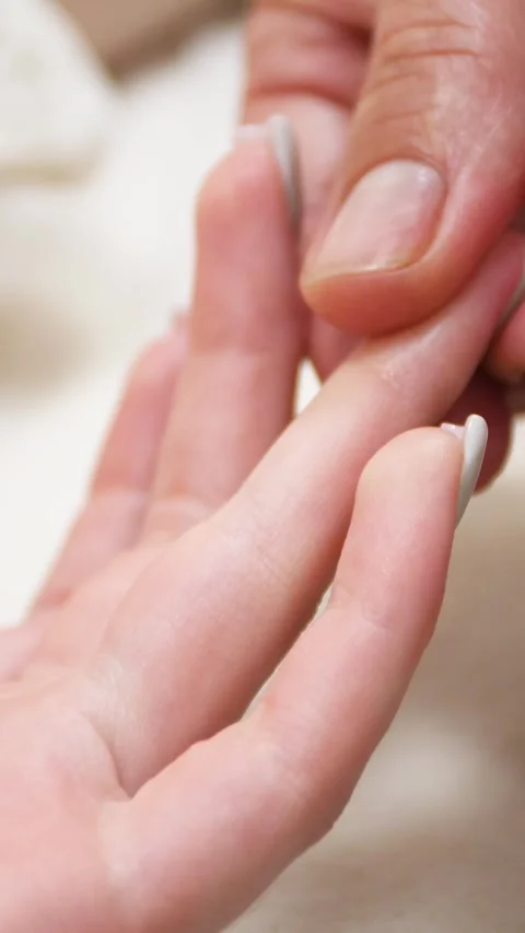 Spa. A massage therapist is working with a young woman - Vertical video Stock Footage 336484961
