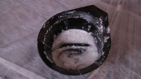 The spa master picks up a scrub from a container. Close-up. Stock Footage 133294500