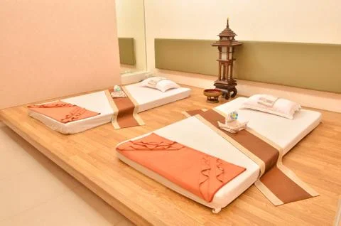 Spa room with interior consisting of bed, pillows and towels Stock Photos