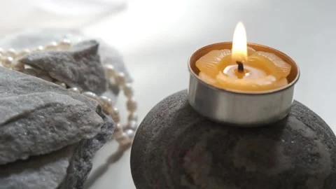 Spa salon, Natural Alternative Therapy . Candle and perls on stone Stock Footage 294735706