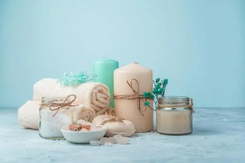 Spa set with candles on a light blue background. Side view with copy space. Stock Photos