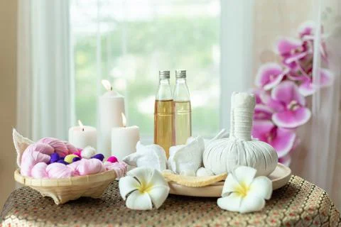 Spa set for massage place on table near window Stock Photos