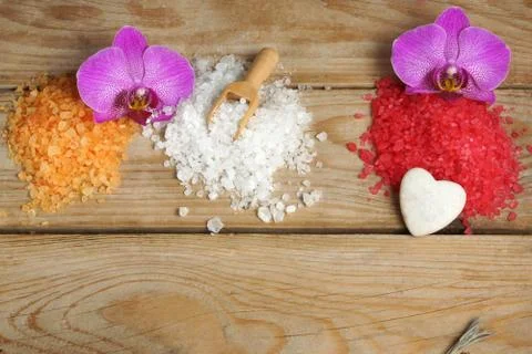  Spa set with multi-colored slides of sea bath salt and orchid flowers on a w Stock Photos