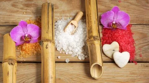  Spa set with multi-colored slides of sea bath salt, bamboo tubes and orchid  Stock Photos