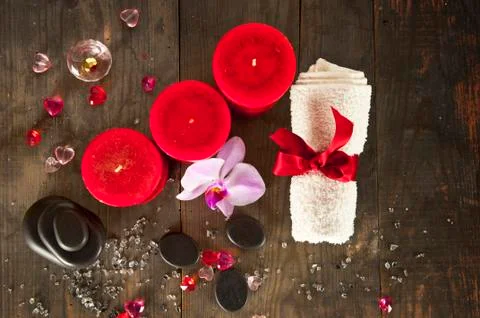 Spa set. Top view: candles, massage stones, towel on natural background Stock Photos