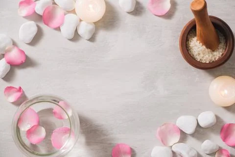 Spa settings with roses. Spa theme with candles and flowers on table. Stock Photos