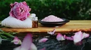 Spa Zen Relaxation With Pink Waterlily Lotus And Pink Himalayan Salt On Water Stock Footage