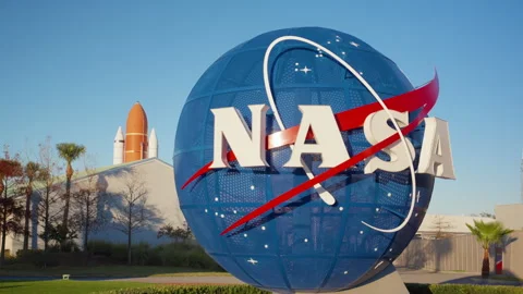 Space agency globe sculpture with shuttle display in background on sunny day Stock Footage 342579189