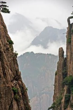 Space between two vertical rocks reveals a spectacular mountain vista, huang  Stock Photos